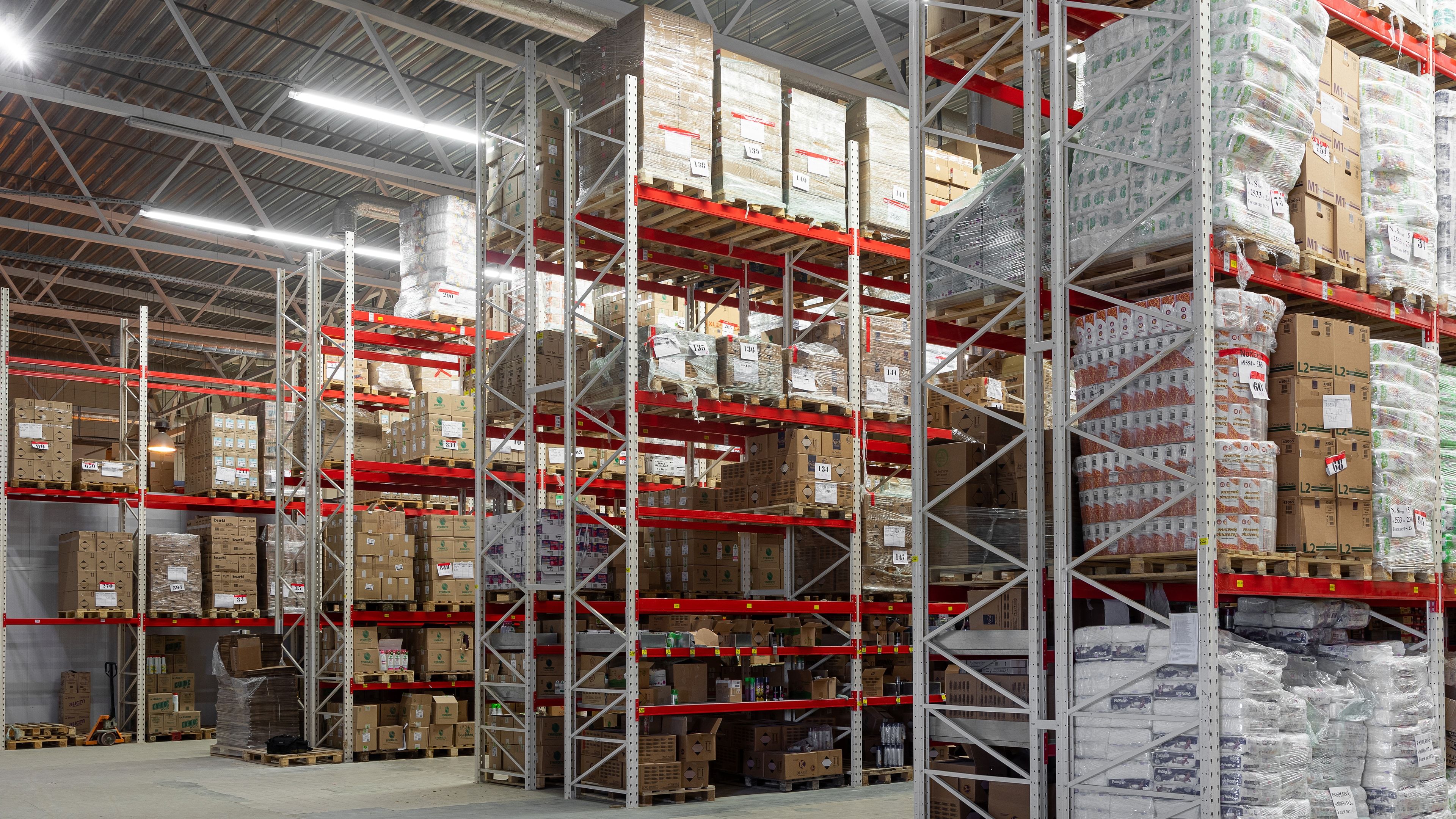 Nave de un centro de distribución con estanterías de gran altura cargadas de palés